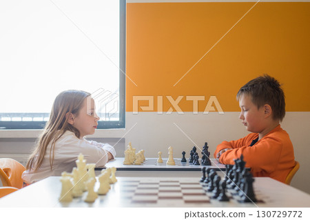Smart children school student playing chess in classroom at school Smart children school student playing chess in classroom at school 130729772