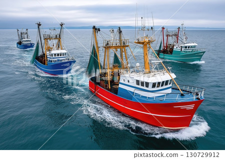 Fishing vessels sailing in formation on open sea 130729912