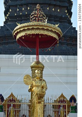 Golden Buddha statue in front of the 12 Zodiac pagoda at Wat Den Sali Si Mueang Kaen. 130730004