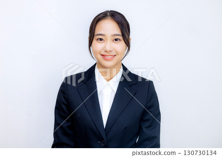 A young woman in a suit talking to the camera 130730134