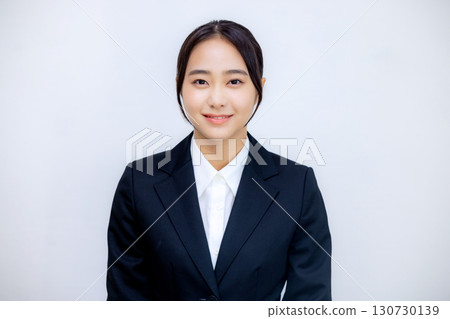 A young woman in a suit talking to the camera A young woman in a suit talking to the camera 130730139