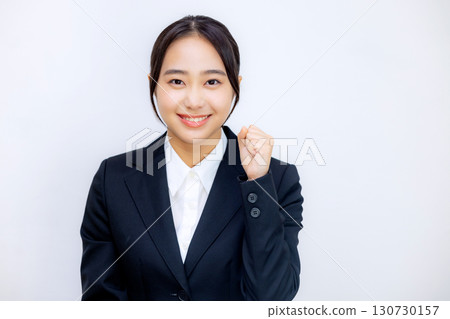 A young woman in a suit talking to the camera 130730157