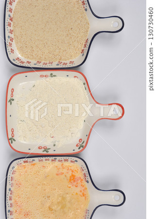 Beaten eggs, flour, and breadcrumbs for breading Beaten eggs, flour, and breadcrumbs for breading 130730460