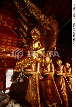 Golden sitting Buddha statue and there is a serpent covering the back in Buddhist Thai Church at Wat Den Sali Si Mueang Kaen temple. Located at Chiang Mai city in Thailand. Golden sitting Buddha statue and there is a serpent covering the back in Buddhist Thai Church at Wat Den Sali Si Mueang Kaen temple. Located at Chiang Mai city in Thailand. 130730632