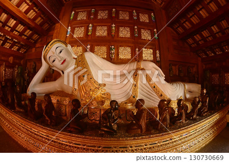 The Reclining white statue Buddha is enshrined in a teakwood chapel at Wat Den Sali Si Mueang Kaen temple or Wat Ban Den. Located at Chiang Mai Province in Thailand. 130730669