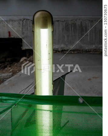 Fluorescent Tube Light Fixture at Construction Walkway. Fluorescent Tube Light Fixture at Construction Walkway. 130730675