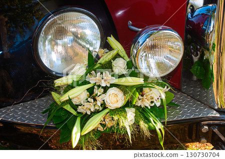 Vintage Car Decorated with Elegant Floral Arrangement of White Roses and Lilies Vintage Car Decorated with Elegant Floral Arrangement of White Roses and Lilies 130730704