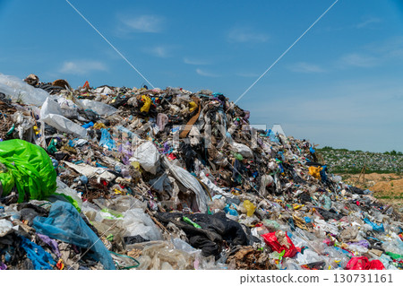 Massive heap of plastic waste and garbage at an open outdoor landfill site under a clear blue sky. Massive heap of plastic waste and garbage at an open outdoor landfill site under a clear blue sky. 130731161