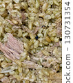 Macro of cooked freekah and shredded meat mixture, showing texture and moist detail, homemade dish, healthy rustic food, hearty meal, and culinary background 130731354