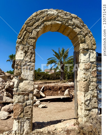 Stone archway of ancient ruins against blue sky. Stone archway of ancient ruins against blue sky. 130731418