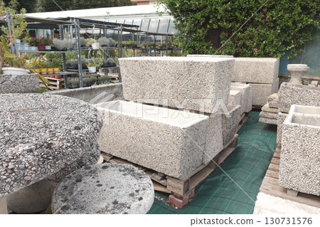 Outdoor pots made of natural stone for garden in European stores. Gardening and hobby. Nature and plants. Outdoor pots made of natural stone for garden in European stores. Gardening and hobby. Nature and plants. 130731576