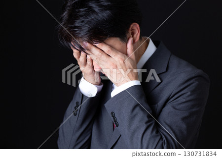 A middle-aged male businessman in a suit who is worried 130731834
