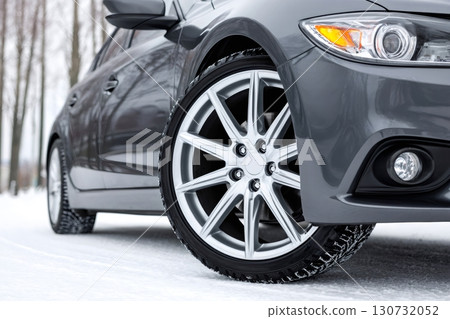 Close up of car wheel with winter tires on snowy road 130732052