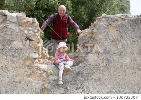 girl and grandfather posing at fortress ruins in Portugal girl and grandfather posing at fortress ruins in Portugal 130732307