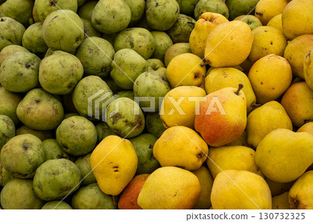 green and yellow pears at the market, top view green and yellow pears at the market, top view 130732325