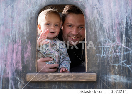 Father and his little daughter outdoors  130732343