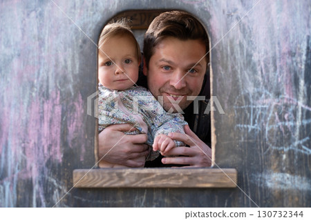 Father and his little daughter outdoors  130732344