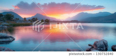 Breathtaking Sunrise Over a Serene Mountain Lake with Vibrant Reflections and Tranquil Surroundings 130732840