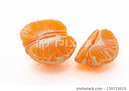 A small mandarin orange is cut in half A small mandarin orange is cut in half 130733629
