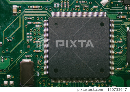 A black chip on a green circuit board A black chip on a green circuit board 130733647