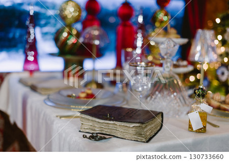 A book is on a table with a white tablecloth A book is on a table with a white tablecloth 130733660