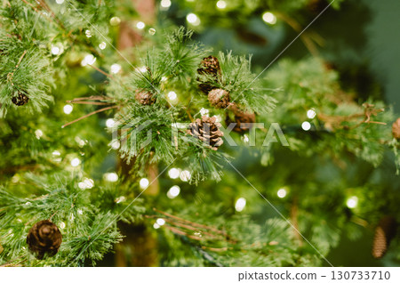 A Christmas tree with a lot of pine cones on it 130733710