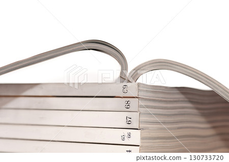 A stack of books with the numbers 1 through 9 on the spine 130733720