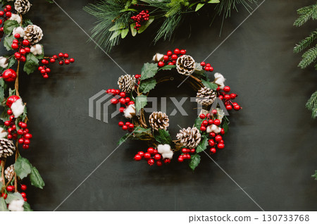 Wreath with red berries and pine cones 130733768