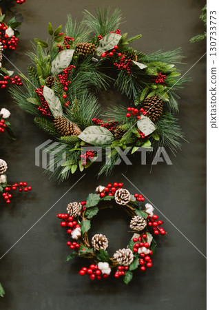 Two wreaths with red berries and pine cones 130733773