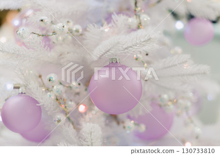 A white Christmas tree with a pink ball on it A white Christmas tree with a pink ball on it 130733810