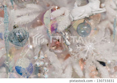 A white Christmas tree with many decorations including a bell A white Christmas tree with many decorations including a bell 130733831