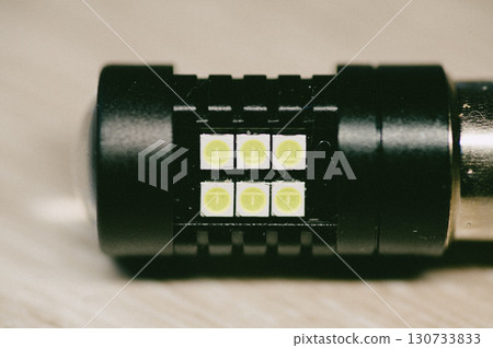 A light bulb with six green lights 130733833