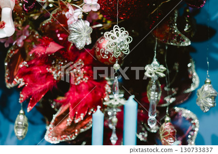 A Christmas tree with many ornaments and candles 130733837