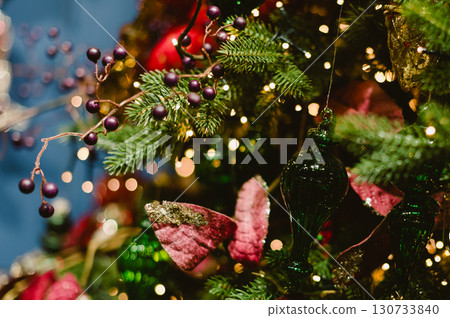 A Christmas tree with green and red decorations 130733840