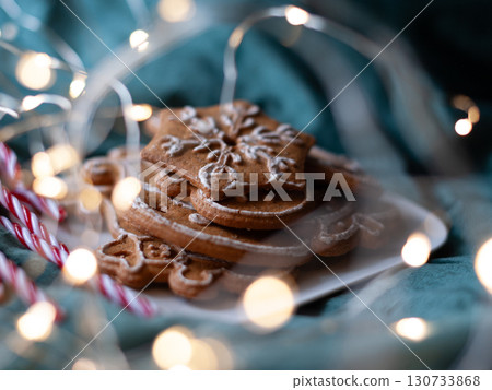 A plate of gingerbread cookies with a snowflake on top. Christmas A plate of gingerbread cookies with a snowflake on top. Christmas 130733868