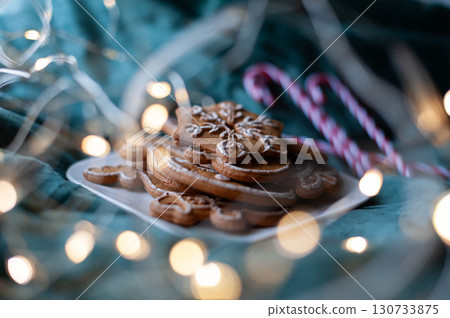 A plate of gingerbread cookies with a snowflake on top. Christmas A plate of gingerbread cookies with a snowflake on top. Christmas 130733875