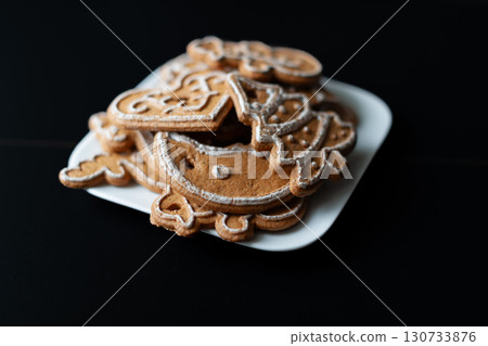 A plate of Christmas cookies with a tree and snowman on it 130733876