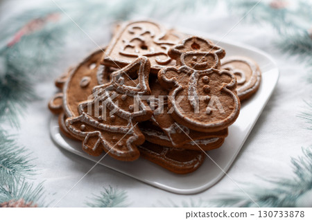 A plate of gingerbread cookies with a tree and a snowman on it. Christmas A plate of gingerbread cookies with a tree and a snowman on it. Christmas 130733878