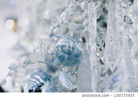 A Christmas tree with a blue ornament hanging from it A Christmas tree with a blue ornament hanging from it 130733935
