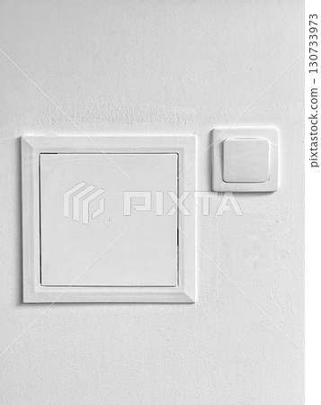 A white box with a white switch on it A white box with a white switch on it 130733973