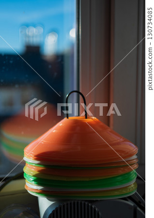 Stacks of Sport marker cone on training pitch. Stacks of Sport marker cone on training pitch. 130734085