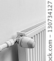A radiator with a thermostat on it 130734127
