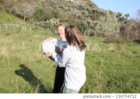 teenage girl playing ball outside, lifestyle people concept 130734712