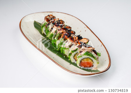 Delicious Japanese fusion sushi roll with salmon, mussels, chuka seaweed, pickled radish 130734819