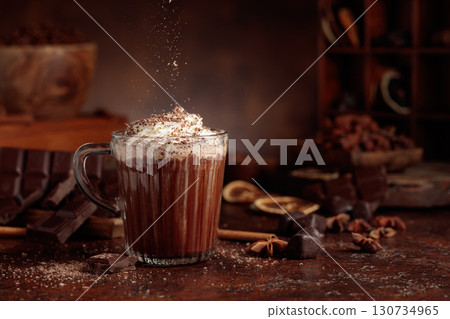 Hot chocolate topped with whipped cream and sprinkled with chocolate chips. Hot chocolate topped with whipped cream and sprinkled with chocolate chips. 130734965