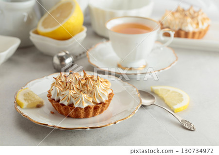 Meringue lemon tart on a white table. Meringue lemon tart on a white table. 130734972