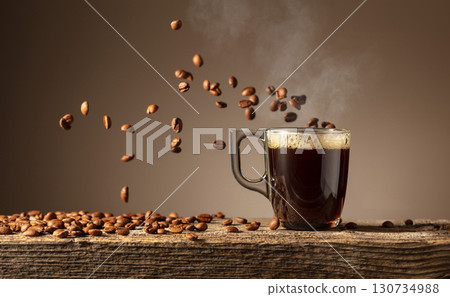 Espresso in glass cup on a old wooden table. 130734988