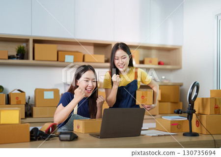 Motivation. Joyful professionals celebrating achievements in e-commerce workspace. Motivation. Joyful professionals celebrating achievements in e-commerce workspace. 130735694