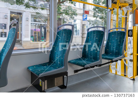 Modern public transport interior showcases clean empty teal patterned seats, highlighting urban travel efficiency and comfortable city commuting 130737163