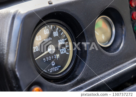 Classic dashboard speedometer shows speed, 53212 kilometers traveled, analog gauges, indicator lights, reflecting enduring vehicle performance, journey Classic dashboard speedometer shows speed, 53212 kilometers traveled, analog gauges, indicator lights, reflecting enduring vehicle performance, journey 130737272